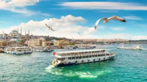 "Bosphorus cruise boat sailing between Europe and Asia with view of Istanbul skyline and Bosphorus Bridge